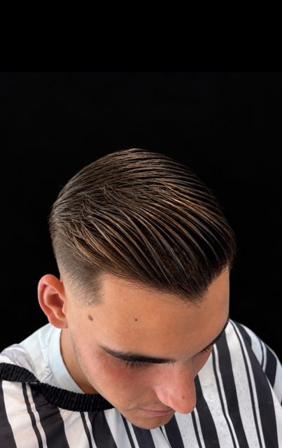 A low skin fade with a swept top